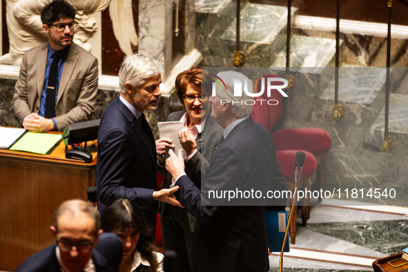 In Paris, France, on November 26, 2024, French Prime Minister Michel Barnier (right) discusses with Laurent Wauquiez (left), President of th...