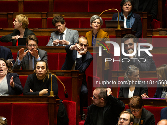 Pouria Amirshahi, deputy of the Ecologiste et Social group, makes the thumbs down sign during the questions to the French government session...