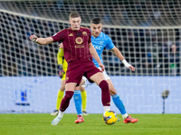 Alessandro Buongiorno of SSC Napoli and Artem Dovbyk of AS Roma compete for the ball during the serie Serie A Enilive match between SSC Napo...