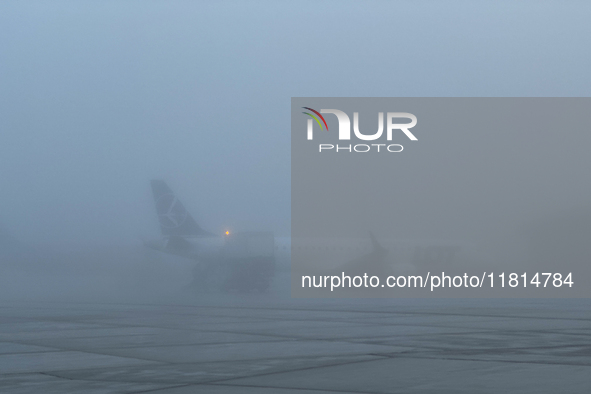 LOT Polish Airlines plane is seen on the foggy morning at the airport in Balice near Krakow, Poland on November 27, 2024. 