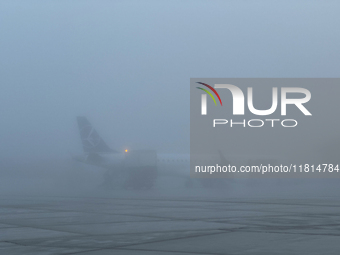 LOT Polish Airlines plane is seen on the foggy morning at the airport in Balice near Krakow, Poland on November 27, 2024. (