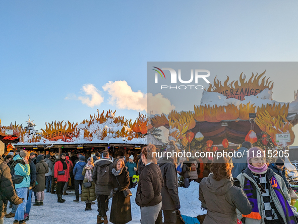 A snow-covered scene at the Winter Tollwood Festival on December 3, 2023, in Munich, Germany, shows the event's focus on art, culture, and s...