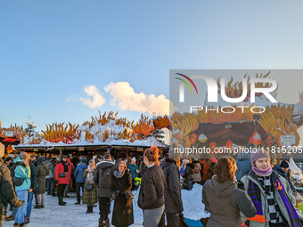 A snow-covered scene at the Winter Tollwood Festival on December 3, 2023, in Munich, Germany, shows the event's focus on art, culture, and s...