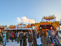 A snow-covered scene at the Winter Tollwood Festival on December 3, 2023, in Munich, Germany, shows the event's focus on art, culture, and s...