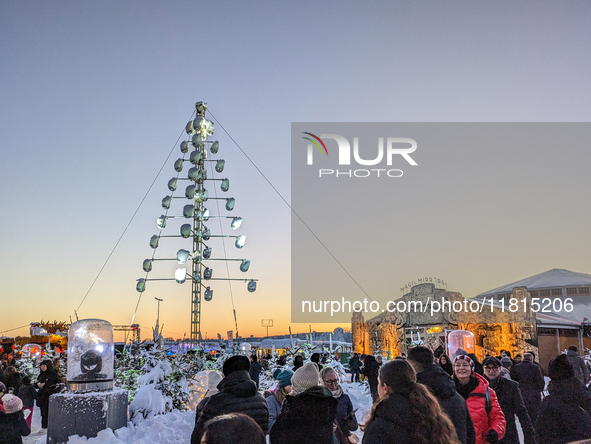 A snow-covered scene at the Winter Tollwood Festival on December 3, 2023, in Munich, Germany, shows the event's focus on art, culture, and s...