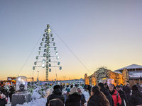 A snow-covered scene at the Winter Tollwood Festival on December 3, 2023, in Munich, Germany, shows the event's focus on art, culture, and s...