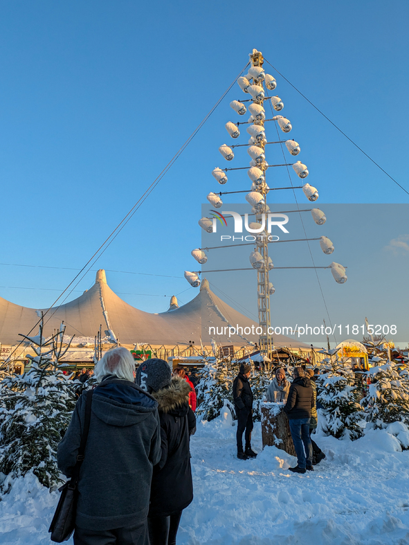 A snow-covered scene at the Winter Tollwood Festival on December 3, 2023, in Munich, Germany, shows the event's focus on art, culture, and s...