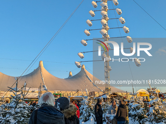 A snow-covered scene at the Winter Tollwood Festival on December 3, 2023, in Munich, Germany, shows the event's focus on art, culture, and s...