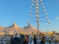 A snow-covered scene at the Winter Tollwood Festival on December 3, 2023, in Munich, Germany, shows the event's focus on art, culture, and s...