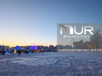 A snow-covered scene at the Winter Tollwood Festival on December 3, 2023, in Munich, Germany, shows the event's focus on art, culture, and s...