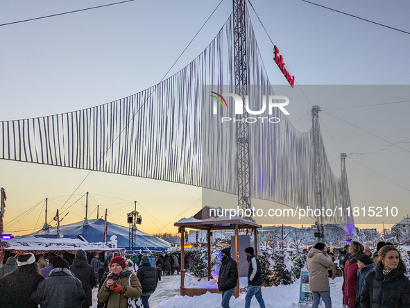 A snow-covered scene at the Winter Tollwood Festival on December 3, 2023, in Munich, Germany, shows the event's focus on art, culture, and s...