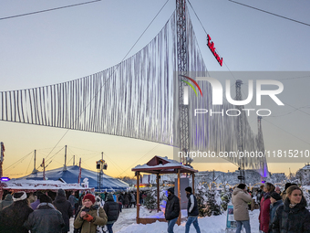 A snow-covered scene at the Winter Tollwood Festival on December 3, 2023, in Munich, Germany, shows the event's focus on art, culture, and s...