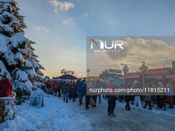 A snow-covered scene at the Winter Tollwood Festival on December 3, 2023, in Munich, Germany, shows the event's focus on art, culture, and s...