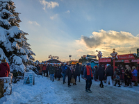 A snow-covered scene at the Winter Tollwood Festival on December 3, 2023, in Munich, Germany, shows the event's focus on art, culture, and s...