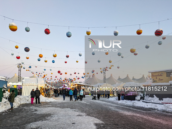 A snow-covered scene at the Winter Tollwood Festival on December 3, 2023, in Munich, Germany, shows the event's focus on art, culture, and s...