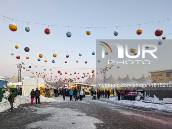 A snow-covered scene at the Winter Tollwood Festival on December 3, 2023, in Munich, Germany, shows the event's focus on art, culture, and s...