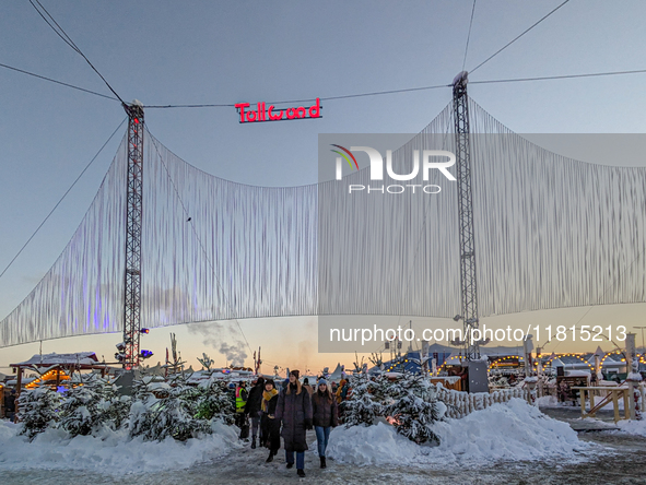 A snow-covered scene at the Winter Tollwood Festival on December 3, 2023, in Munich, Germany, shows the event's focus on art, culture, and s...