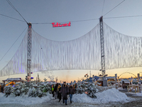 A snow-covered scene at the Winter Tollwood Festival on December 3, 2023, in Munich, Germany, shows the event's focus on art, culture, and s...