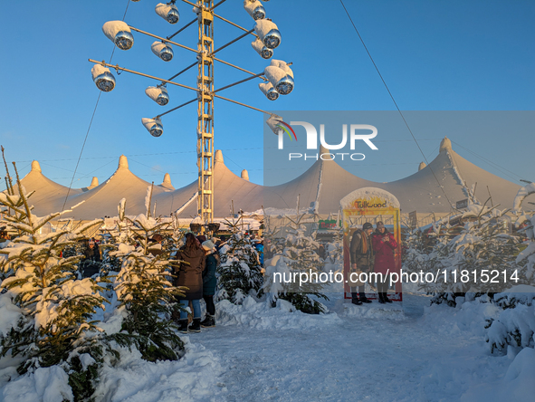 A snow-covered scene at the Winter Tollwood Festival on December 3, 2023, in Munich, Germany, shows the event's focus on art, culture, and s...