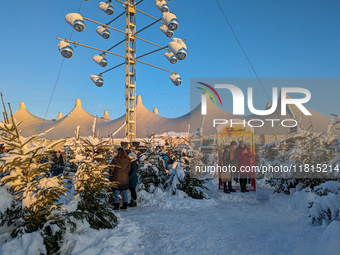 A snow-covered scene at the Winter Tollwood Festival on December 3, 2023, in Munich, Germany, shows the event's focus on art, culture, and s...