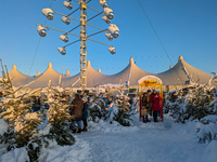 A snow-covered scene at the Winter Tollwood Festival on December 3, 2023, in Munich, Germany, shows the event's focus on art, culture, and s...