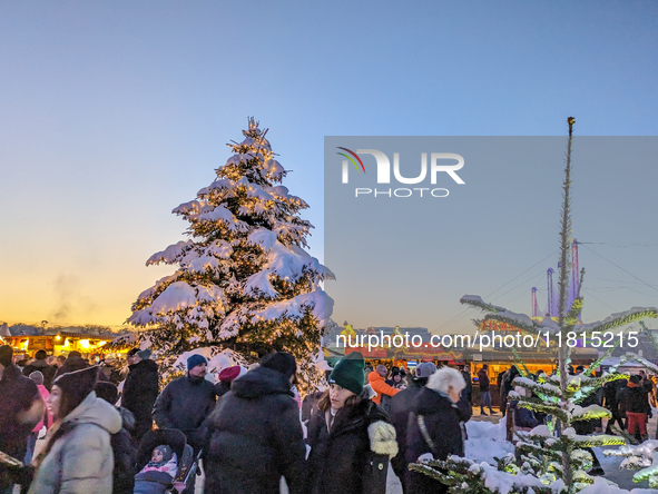 A snow-covered scene at the Winter Tollwood Festival on December 3, 2023, in Munich, Germany, shows the event's focus on art, culture, and s...