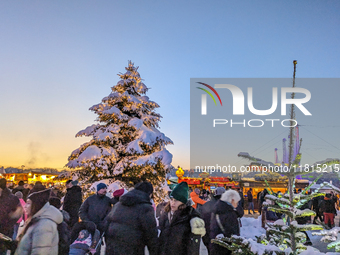 A snow-covered scene at the Winter Tollwood Festival on December 3, 2023, in Munich, Germany, shows the event's focus on art, culture, and s...