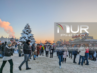 A snow-covered scene at the Winter Tollwood Festival on December 3, 2023, in Munich, Germany, shows the event's focus on art, culture, and s...