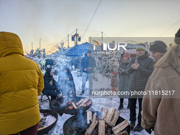 A snow-covered scene at the Winter Tollwood Festival on December 3, 2023, in Munich, Germany, shows the event's focus on art, culture, and s...