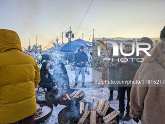 A snow-covered scene at the Winter Tollwood Festival on December 3, 2023, in Munich, Germany, shows the event's focus on art, culture, and s...