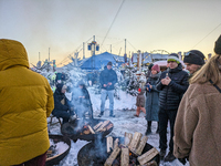 A snow-covered scene at the Winter Tollwood Festival on December 3, 2023, in Munich, Germany, shows the event's focus on art, culture, and s...