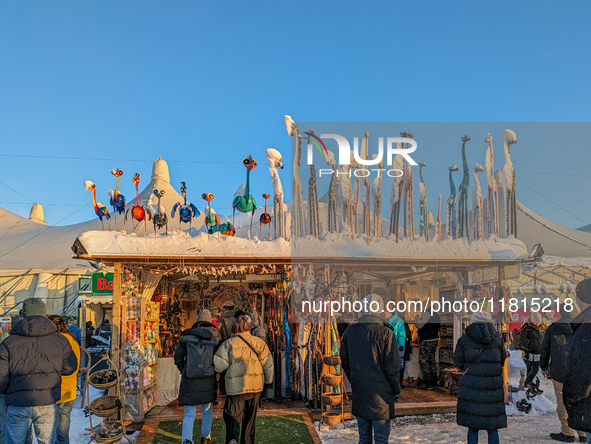 A snow-covered scene at the Winter Tollwood Festival on December 3, 2023, in Munich, Germany, shows the event's focus on art, culture, and s...