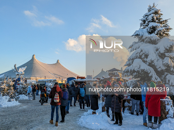 A snow-covered scene at the Winter Tollwood Festival on December 3, 2023, in Munich, Germany, shows the event's focus on art, culture, and s...