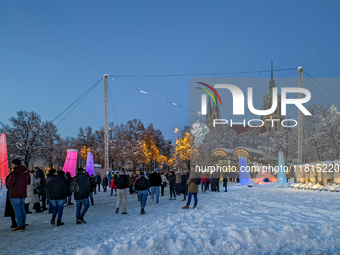 A snow-covered scene at the Winter Tollwood Festival on December 3, 2023, in Munich, Germany, shows the event's focus on art, culture, and s...