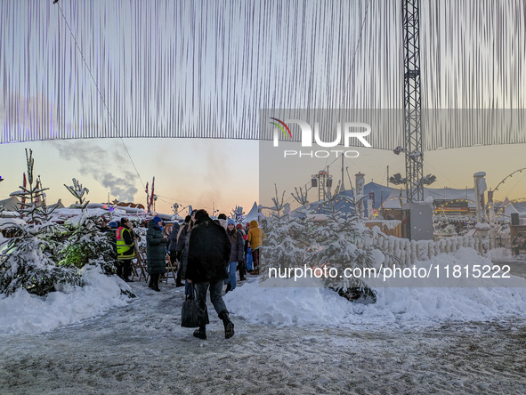 A snow-covered scene at the Winter Tollwood Festival on December 3, 2023, in Munich, Germany, shows the event's focus on art, culture, and s...