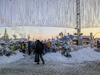 A snow-covered scene at the Winter Tollwood Festival on December 3, 2023, in Munich, Germany, shows the event's focus on art, culture, and s...