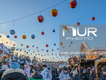 A snow-covered scene at the Winter Tollwood Festival on December 3, 2023, in Munich, Germany, shows the event's focus on art, culture, and s...