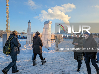 A snow-covered scene at the Winter Tollwood Festival on December 3, 2023, in Munich, Germany, shows the event's focus on art, culture, and s...