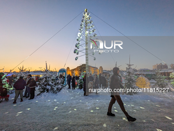 A snow-covered scene at the Winter Tollwood Festival on December 3, 2023, in Munich, Germany, shows the event's focus on art, culture, and s...