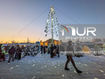 A snow-covered scene at the Winter Tollwood Festival on December 3, 2023, in Munich, Germany, shows the event's focus on art, culture, and s...