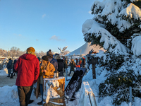 A snow-covered scene at the Winter Tollwood Festival on December 3, 2023, in Munich, Germany, shows the event's focus on art, culture, and s...