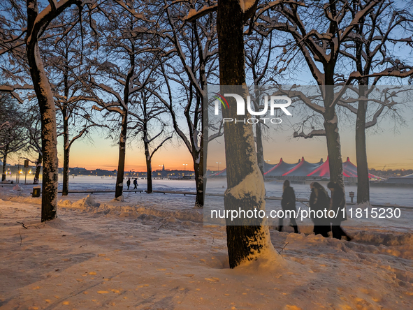 A snow-covered scene at the Winter Tollwood Festival on December 3, 2023, in Munich, Germany, shows the event's focus on art, culture, and s...