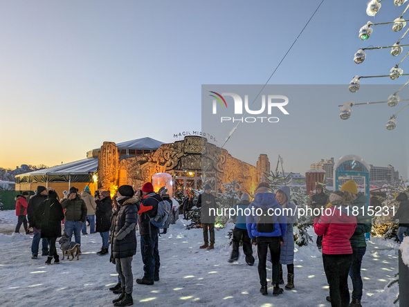 A snow-covered scene at the Winter Tollwood Festival on December 3, 2023, in Munich, Germany, shows the event's focus on art, culture, and s...