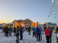 A snow-covered scene at the Winter Tollwood Festival on December 3, 2023, in Munich, Germany, shows the event's focus on art, culture, and s...