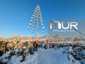 A snow-covered scene at the Winter Tollwood Festival on December 3, 2023, in Munich, Germany, shows the event's focus on art, culture, and s...