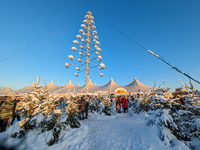 A snow-covered scene at the Winter Tollwood Festival on December 3, 2023, in Munich, Germany, shows the event's focus on art, culture, and s...