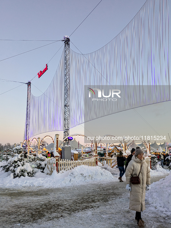 A snow-covered scene at the Winter Tollwood Festival on December 3, 2023, in Munich, Germany, shows the event's focus on art, culture, and s...