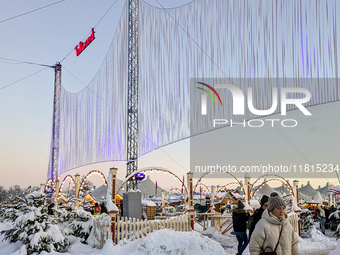 A snow-covered scene at the Winter Tollwood Festival on December 3, 2023, in Munich, Germany, shows the event's focus on art, culture, and s...