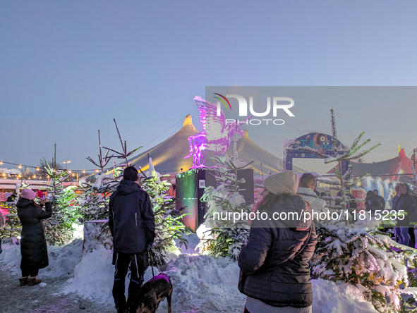 A snow-covered scene at the Winter Tollwood Festival on December 3, 2023, in Munich, Germany, shows the event's focus on art, culture, and s...