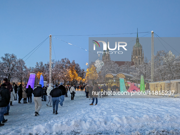 A snow-covered scene at the Winter Tollwood Festival on December 3, 2023, in Munich, Germany, shows the event's focus on art, culture, and s...